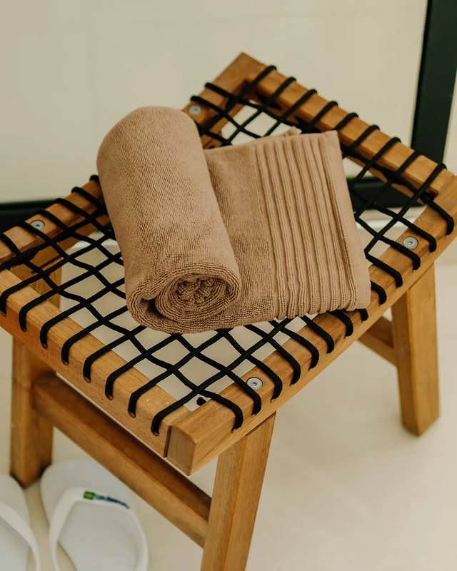 Fresh rolled towels and slippers set out for guests