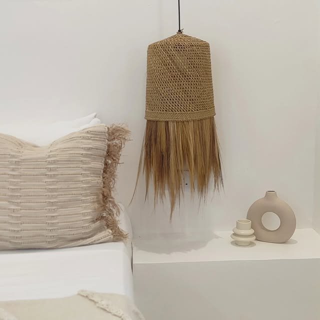 Bedroom nightstand with woven pendant light and ceramics