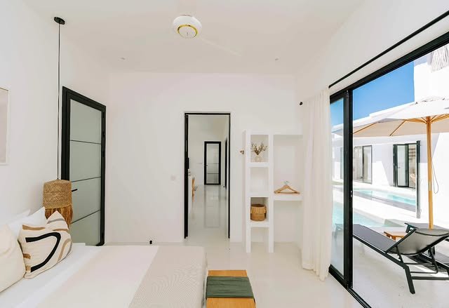 Bedroom in the private two-bedroom villa, opening onto the pool