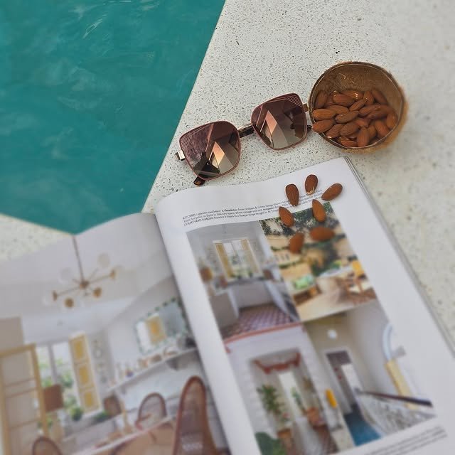 A quiet poolside moment with a magazine and snacks